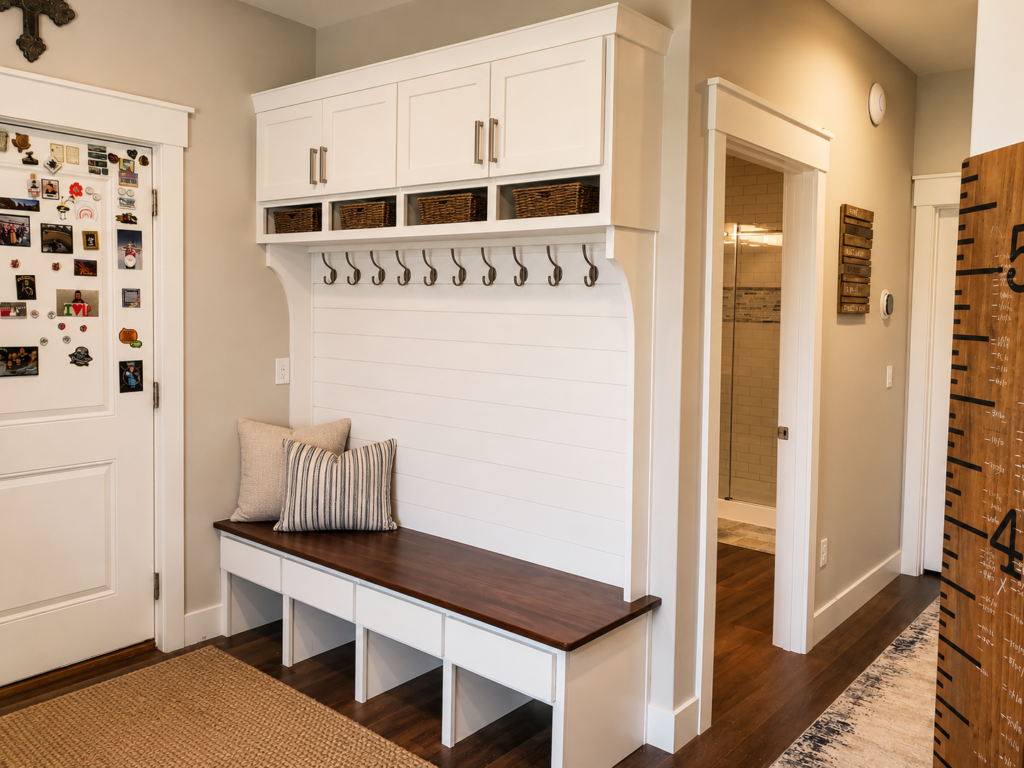 Custom built-in mudroom bench with storage and coat hooks