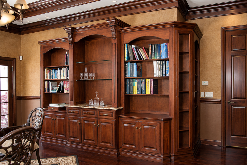 Custom wood professional study with built-in bookcases, cabinetry and architectural millwork